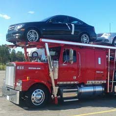 Red truck hauling cars