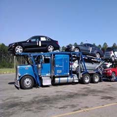 Blue truck hauling cars